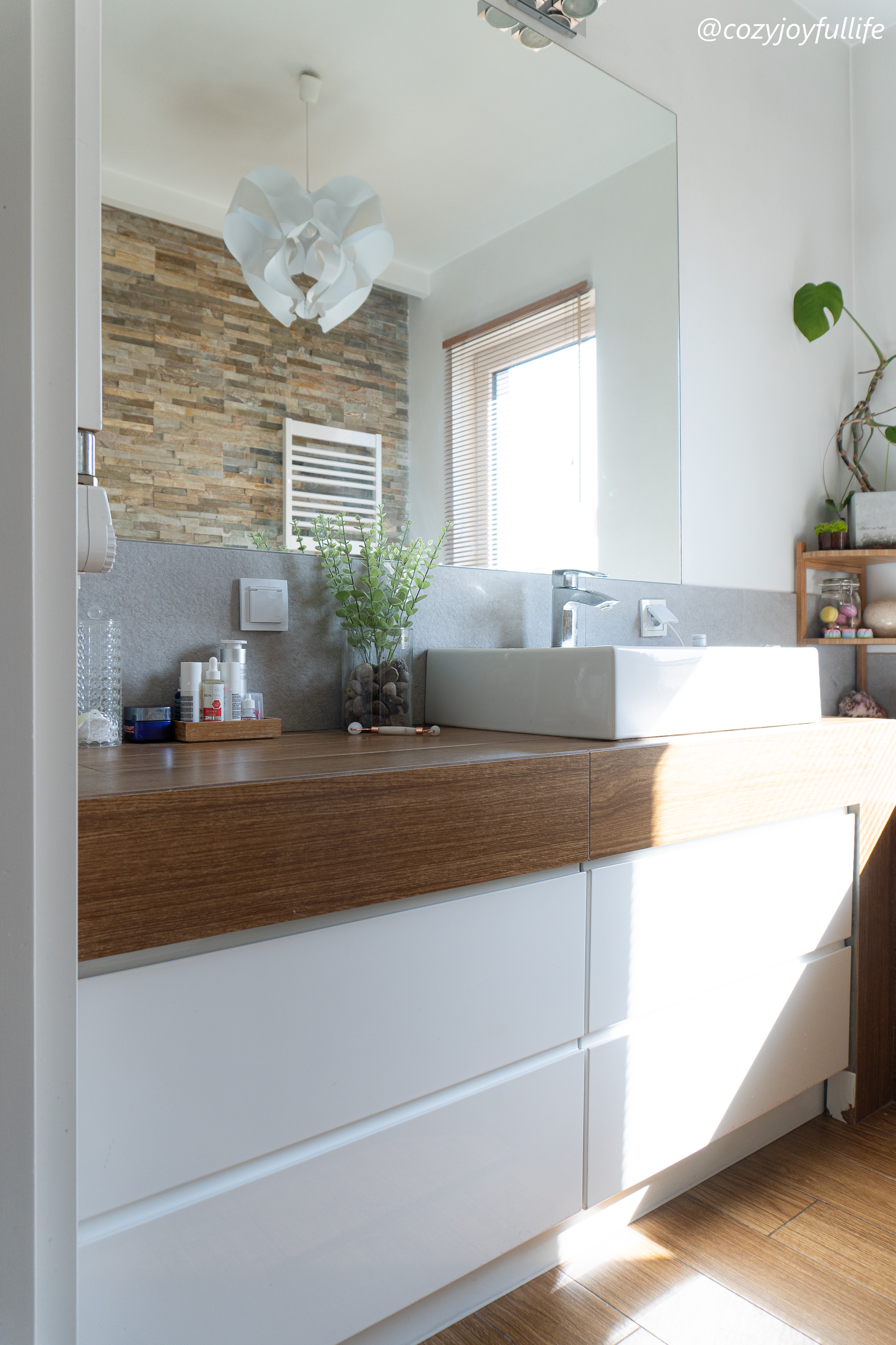 Photo of a bathroom with bathroom vanity built from wood like tiles and custom drawers